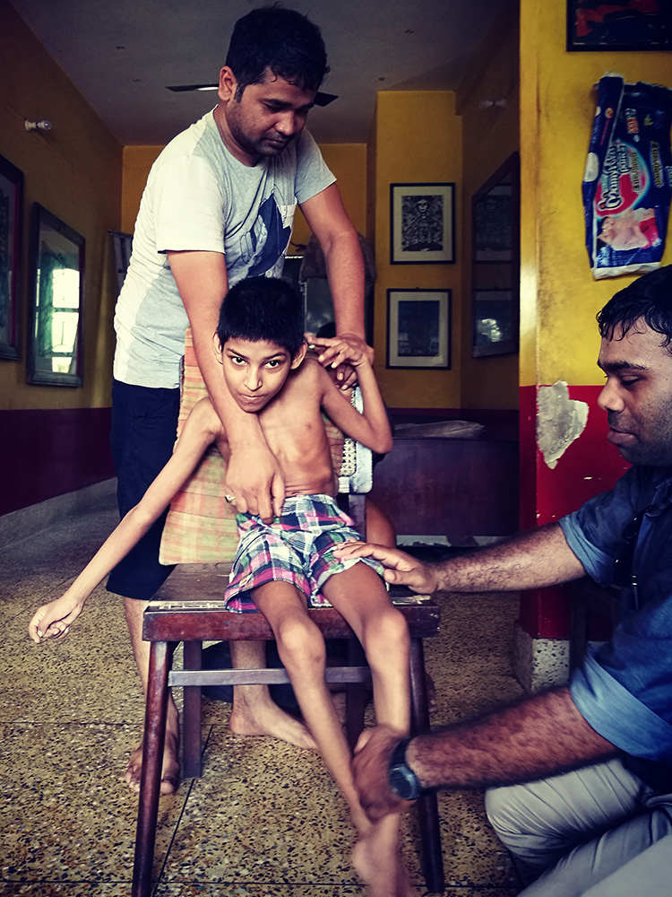 Aakash with his physiotherapist